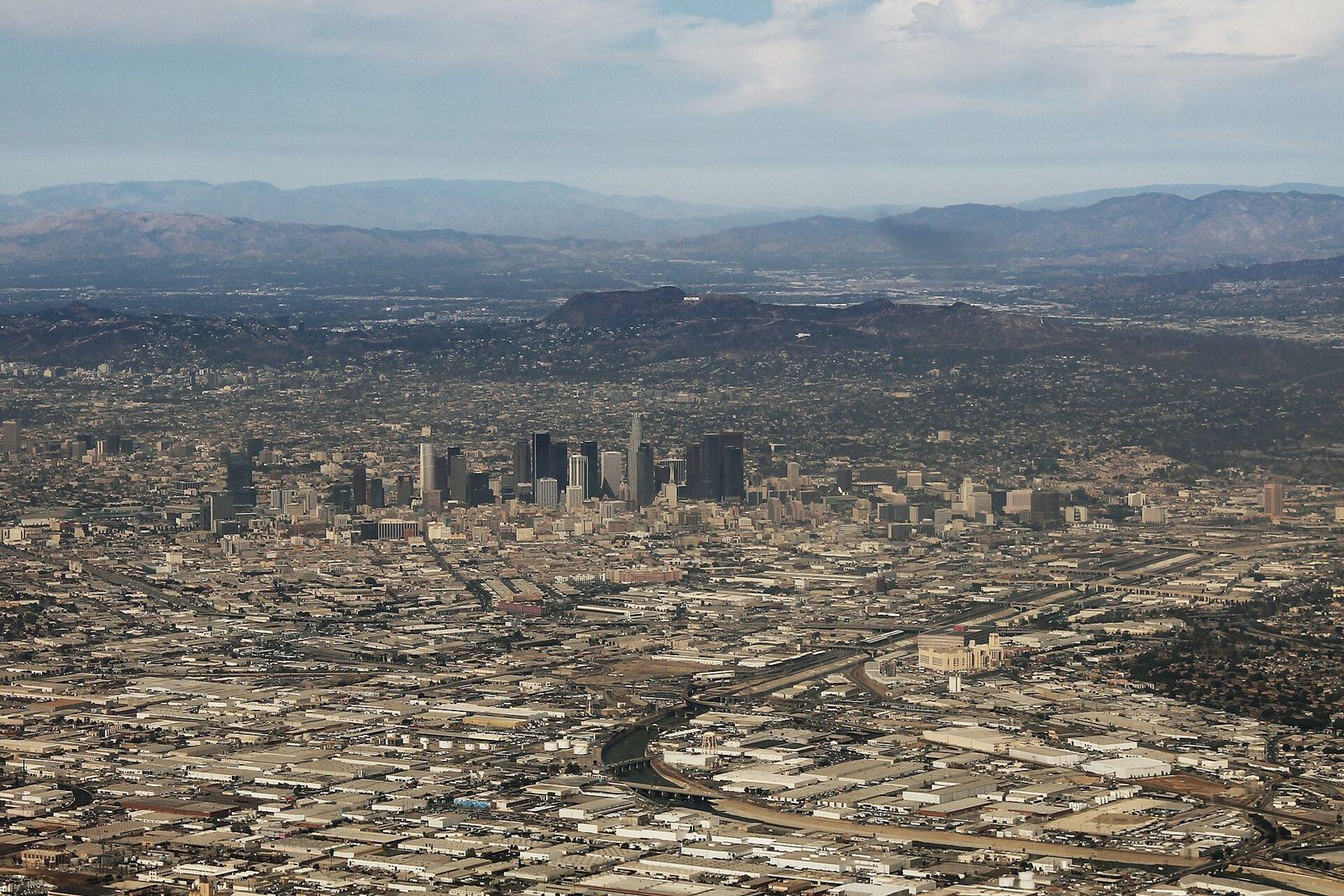 Aerial view of the Los Angeles basin with the downtown skyline and the San Gabriel Mountains behind it