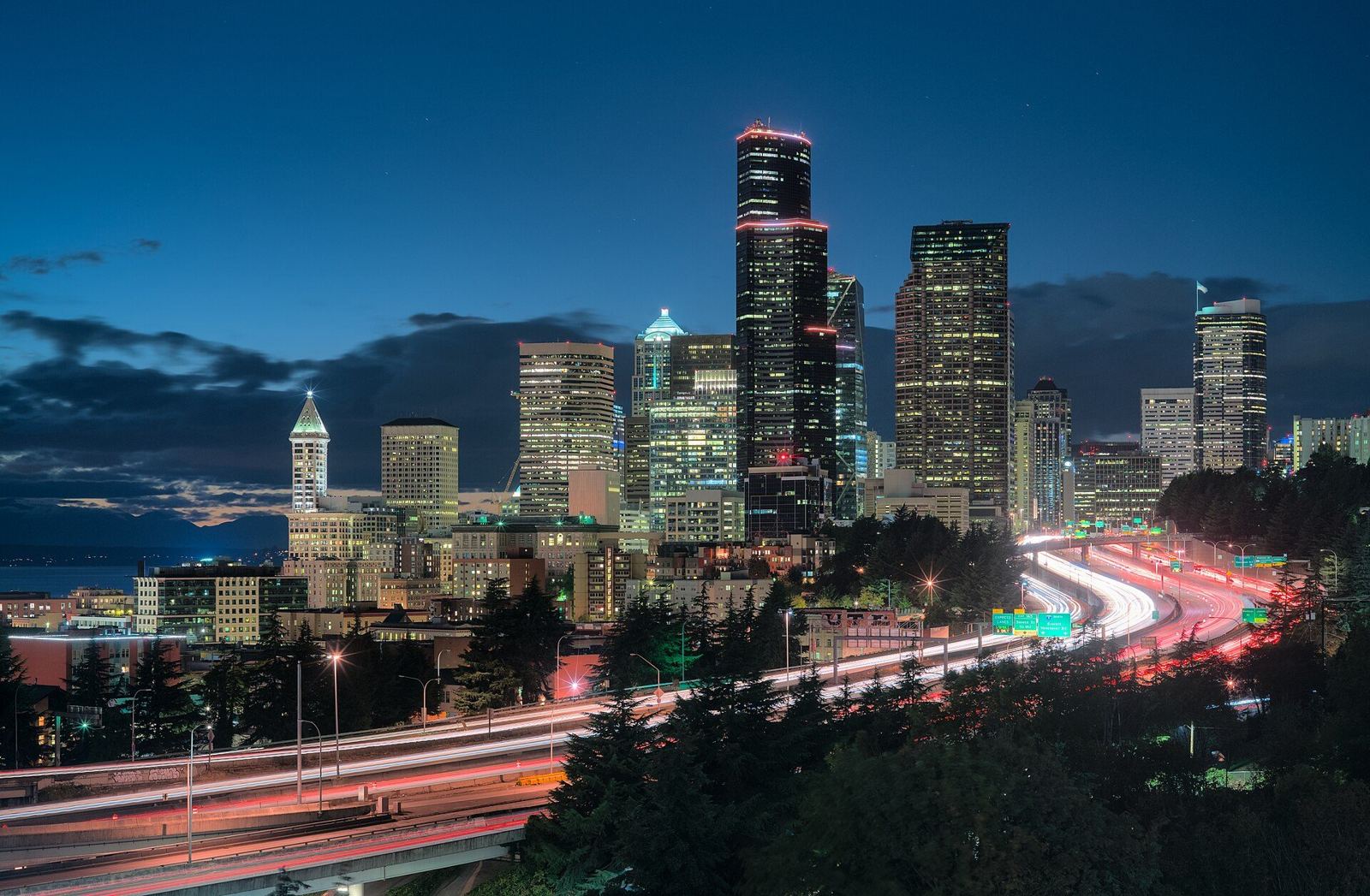 Seattle skyline at night with light trails on Interstate 5